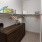 a kitchen with a table and shelves